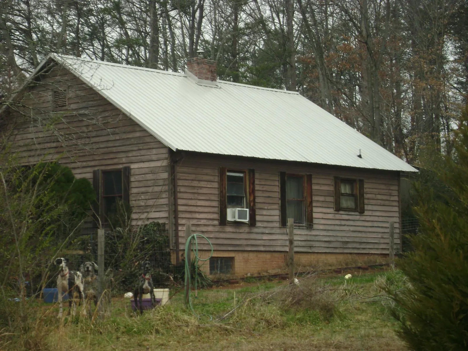 White metal roof on an old wood sided farmhouse, from a Metal Roof Installation job in Ridgewood